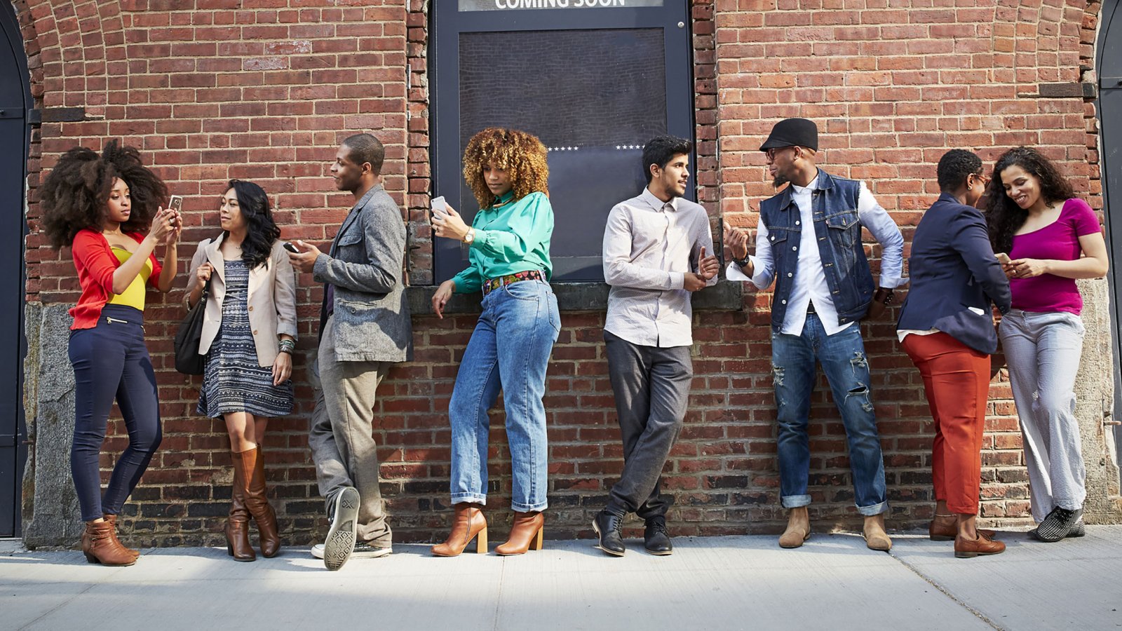 Black, Indigenous and People of Color (BIPOC) waiting in line outside of a theatre.