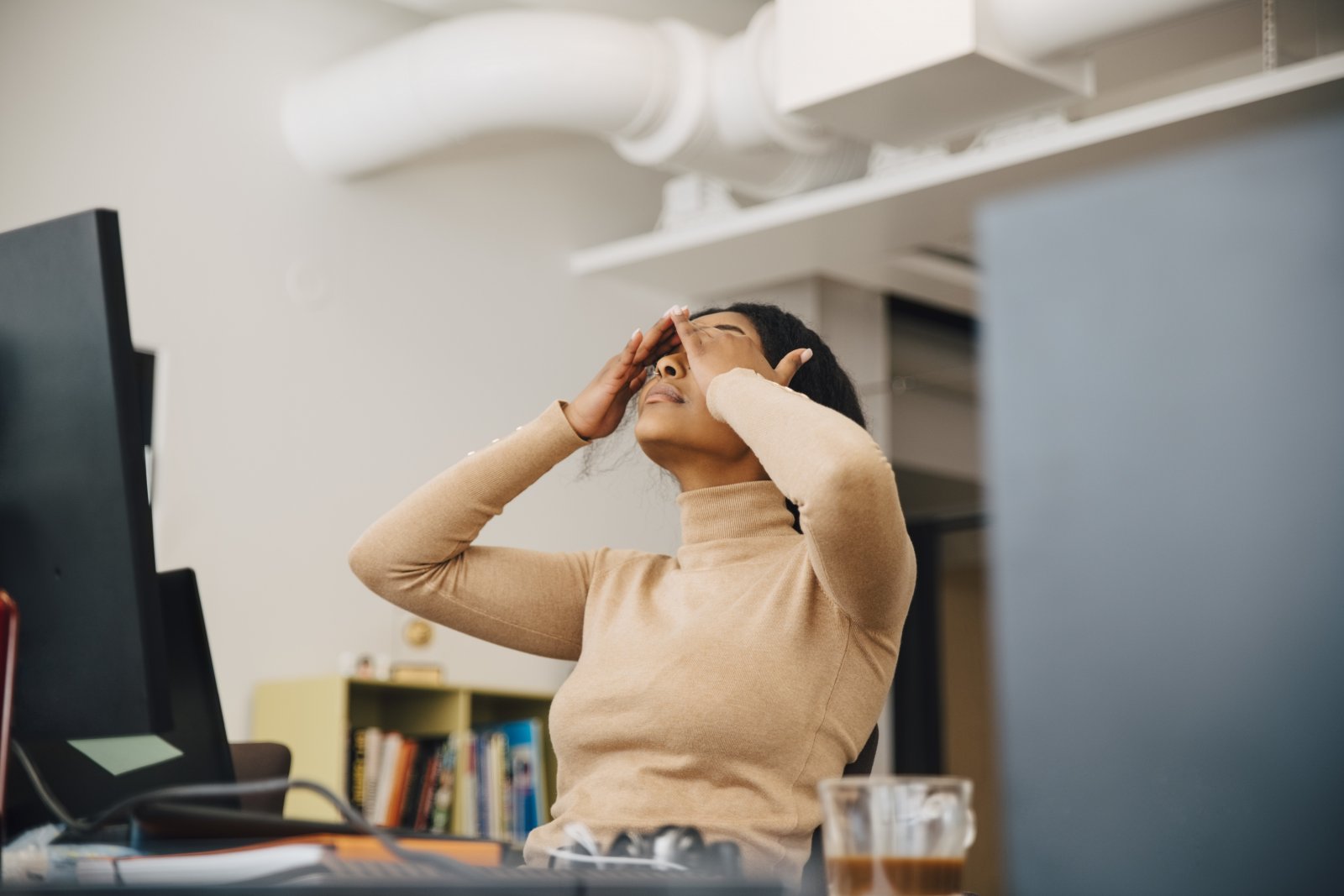 Woman holding her head in anguish