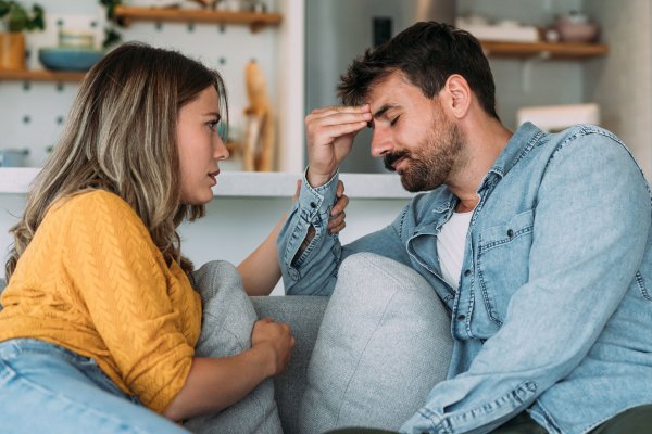 Shot of young wife expressing empathy and compassion to her sad frustrated husband.