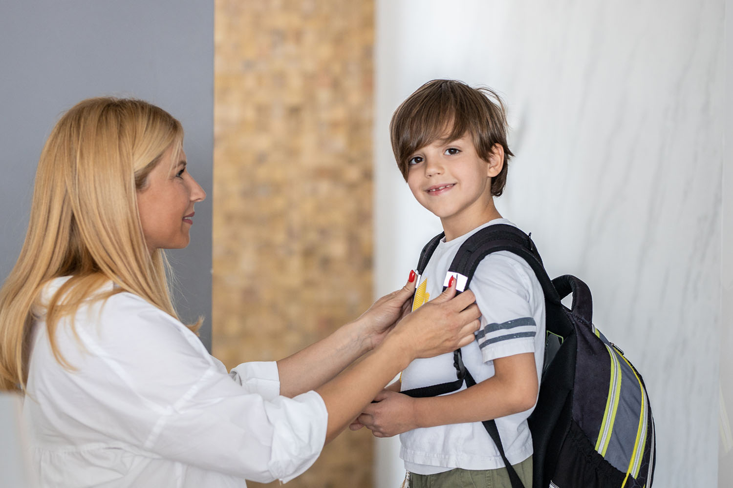 Child with backpack and mother