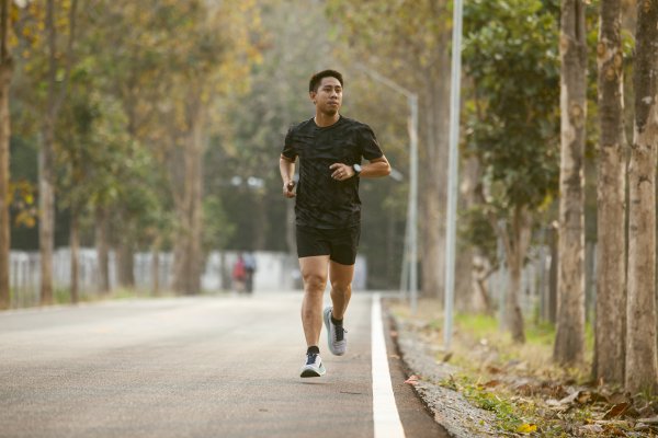 Asian Sportman Jogging And Checking Smart Watch Between Workout Jogging Outdoor