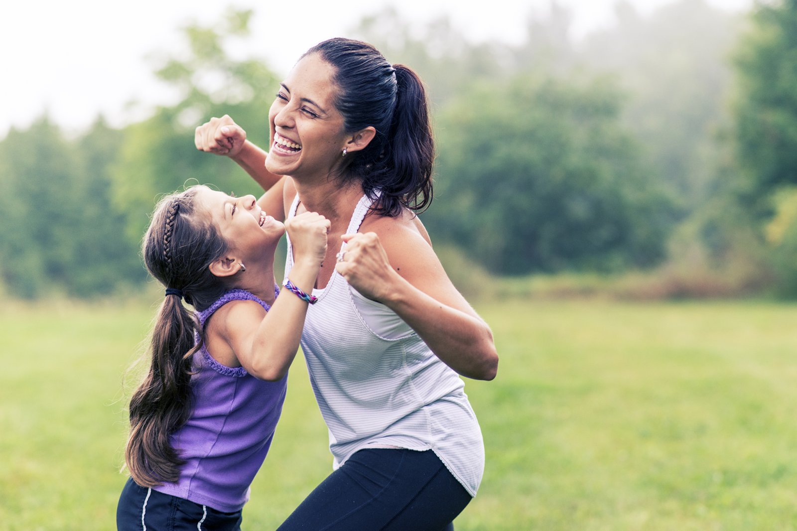 Mother and daughter doing exercises outdoors